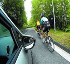 A car passing cyclists on a road