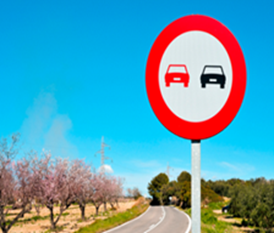 A no-overtaking sign beside a road in Spain